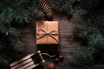 Wall Mural - A frame of fir branches and  gift paper box tied with twine. Christmas card blank.
