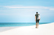 © Irina - Young man with a backpack walking away along the sea shore