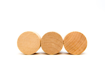 three round wooden toy blocks isolated on white background