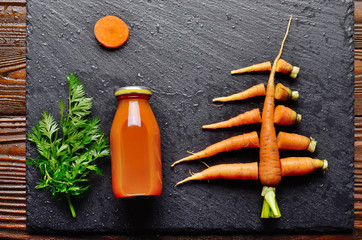 Wall Mural - Top view at stylised christmas tree made of carrots on slate stone tray