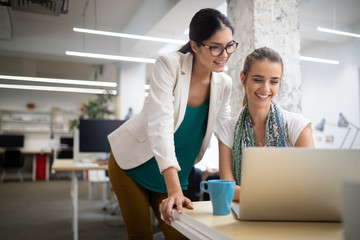 Team of colleagues brainstorming together while working in modern office