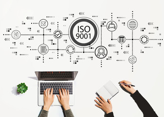 Wall Mural - ISO 9001 with people working together with laptop and notebook