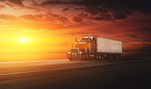 American Style Truck On Freeway Pulling Load At The Sunset. Transportation Concept