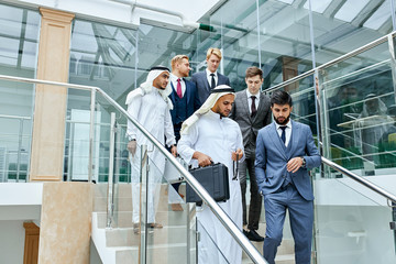 Wall Mural - Confident business people after business conference, meeting. Successful deal, sheikhs and caucasians