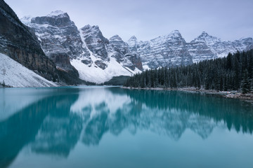 Wall Mural - first snow morning at moraine lake in banff national park alberta canada snow-covered winter mountai