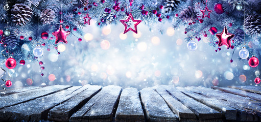 christmas - ornament hanging on cold fir branches with frozen table