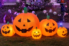 Inflatable Pumpkins Glowing. Halloween Background Decoration Outside A House Front Yard.