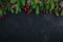 Christmas Tree Decoration Background With Fir Cones And Red Berries.