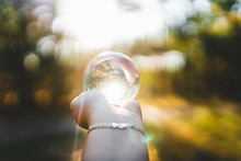 Forest And Warm Sunlight Through A Lensball In Hand 