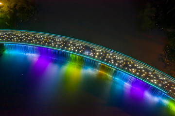 Aerial view of Starlight Bridge or Anh Sao Bridge which is a pedestrian bridge with colored lights and waterfall in District 7 of Ho Chi Minh City also known as Saigon, Vietnam. 