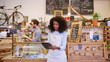 © marvent - African American barista working on a tablet in her cafe