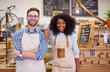 © marvent - Two smiling diverse baristas working together in a trendy cafe