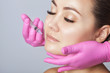© Dimid - The doctor cosmetologist makes Lip augmentation procedure of a beautiful woman in a beauty salon.Cosmetology skin care.