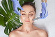 © Dimid - The cosmetologist makes the  Microdermabrasion procedure of the facial skin of a woman in a beauty salon.Cosmetology and professional skin care.