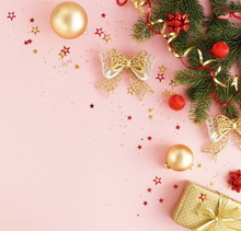 Christmas Background. Xmas Or New Year Gold, Red Color Decorations And Gift On Pink Background With Empty Copy Space For Text.  Holiday And Celebration Concept For Postcard Or Invitation. Top View 