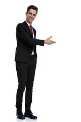 Wall Mural - Positive young businessman presenting and smiling