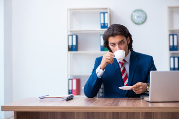 Young male businessman working in the office