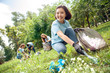 © Viktoriia - Volunteering. Young people volunteers outdoors asian girl picking litter close-up smiling cheerful