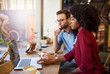 © marvent - Diverse young couple sitting in a cafe using their laptop