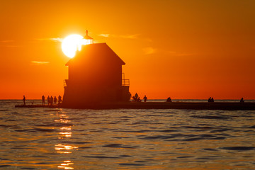 Wall Mural - sunset at sea behind lighthouse