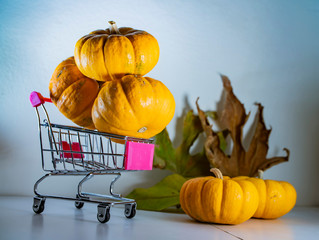 Halloween pumpkins in basket from the supermarket as a symbol of holiday   discounts and autumn sales