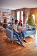 © Krakenimages.com - Family and friends dining at home celebrating christmas eve with traditional food and decoration, romantic senior couple talking together sitting on the sofa