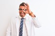 © Krakenimages.com - Young handsome therapist man over isolated background doing ok gesture with hand smiling, eye looking through fingers with happy face.