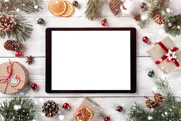 Wall Mural - creative layout frame made of christmas tree branches, pine cones and tablet pc on white wooden back
