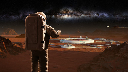 Wall Mural - astronaut on planet Mars, looking at a martian city 