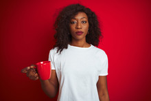Young African American Woman Drinking Cup Of Coffee Over Isolated Red Background With A Confident Expression On Smart Face Thinking Serious
