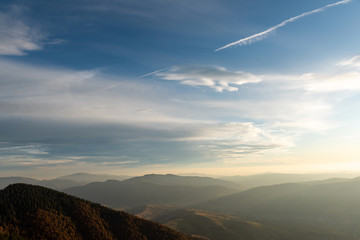 Sticker - Beautiful sunset and layered mountain silhouettes in evening