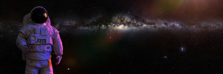 Wall Mural - standing astronaut in front of the milky way galaxy