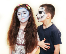Zombie Apocalypse Kids Concept. Birthday Party Celebration Facepaint On Children Dead Bride, And Skeleton Boy And Girl Couple Together Having Fun, Hallooween People