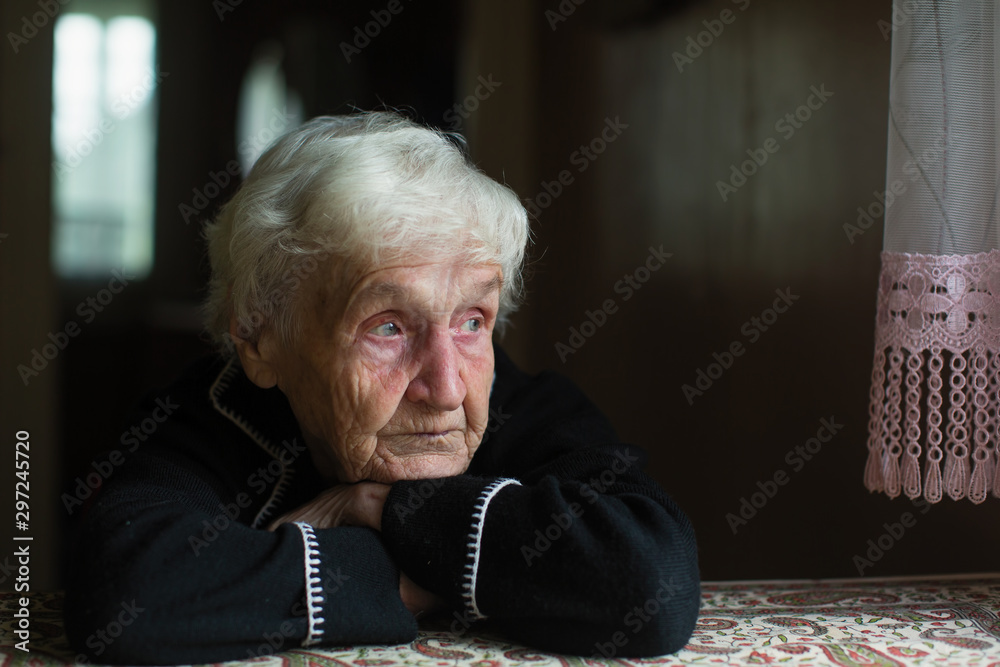 Portrait of sad elderly woman in the his house. - obrazy, fototapety, plakaty 