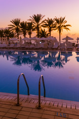 Wall Mural - Swimming pool on Cyprus island at sunset