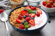 Tasty homemade granola with yogurt on grey table, closeup. Healthy breakfast