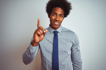 Sticker - American business man with afro hair wearing shirt and tie over isolated white background showing and pointing up with finger number one while smiling confident and happy.