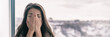 © Maridav - Sad upset young woman crying with mental health seasonal affective disorder at home breathing in hands panoramic background banner. Winter blues.