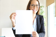 Happy Businesswoman Showing Blank Contract At Office