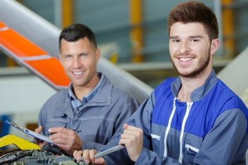 two men working on a machine