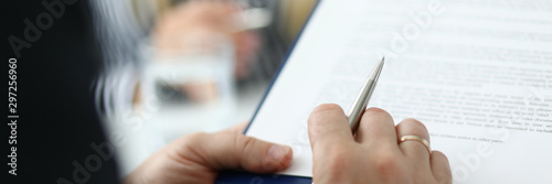 Fotografía Focus on male hand holding pen and paper folder with contract
