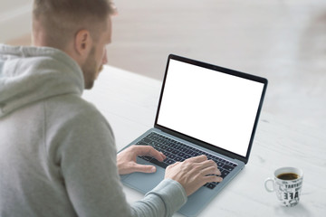 Aufkleber - Guy work on laptop with isolated screen for mockup. Clean work desk with cup of coffee beside.