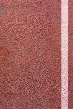 The White Line On Synthetic Rubber Protective Covering. Surface Of Orange Shock Absorbing Coatings From Rubber Chips As Texture Background.