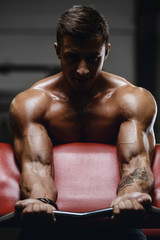 Handsome strong athletic men pumping up biceps muscles workout fitness and bodybuilding concept background - muscular bodybuilder fitness men doing arms exercises in gym naked torso.