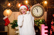 © be free - rush hour. winter holidays. Its time for christmas. girl in red santa claus hat. Midnight. happy new year. christmas preparation. Cheerful woman.. Time to celebrate. xmas mood. Woman wi clock