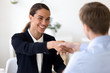 © fizkes - Happy female mixed race manager shaking hands with job applicant.