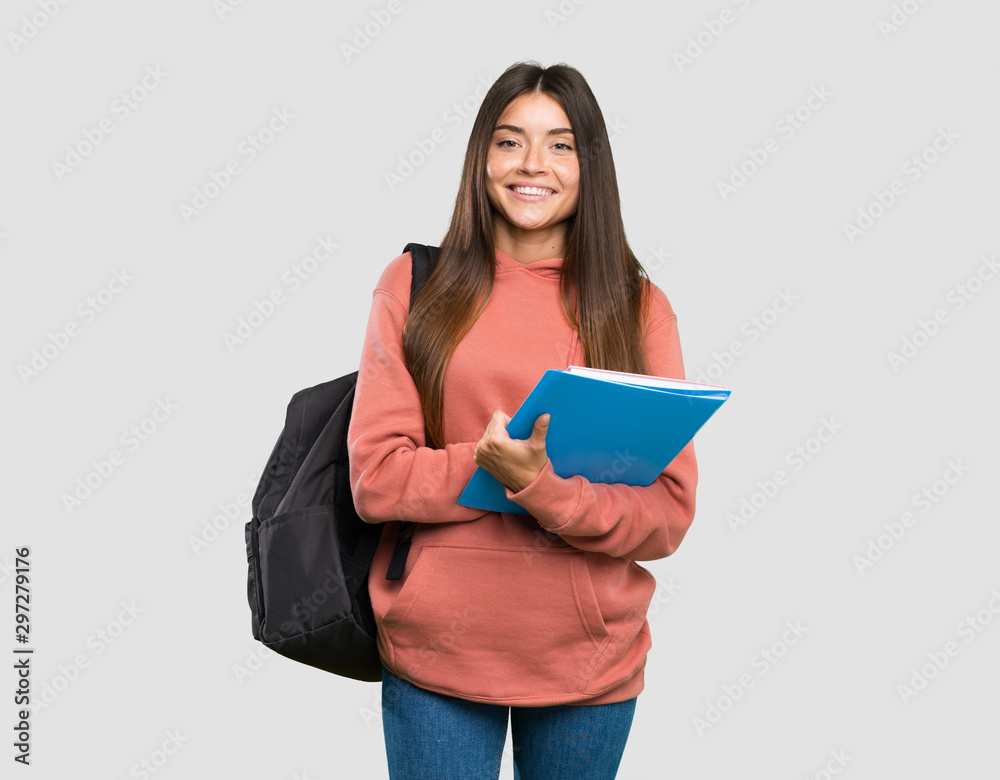 Young student woman holding notebooks keeping the arms crossed in frontal position over isolated grey background - obrazy, fototapety, plakaty 