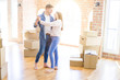 © Krakenimages.com - Beautiful young couple having fun dancing at new apartment, celebrating moving to a new home