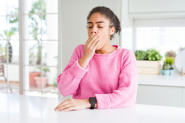 Sticker - Beautiful african american woman with afro hair wearing casual pink sweater bored yawning tired covering mouth with hand. Restless and sleepiness.