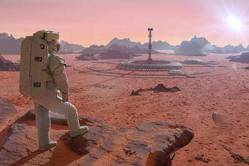 Wall Mural - astronaut on planet mars, looking at a base in the desert landscape